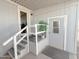 Side entrance porch area with stairs and new storm doors for easy access to the home at 652 S Ellsworth Rd # 46, Mesa, AZ 85208