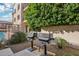 Outdoor barbecue area with two stainless steel gas grills and nearby desert landscaping at 7609 E Indian Bend Rd # 2008, Scottsdale, AZ 85250