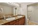 Well-lit bathroom features double sinks, granite countertops, and a mirror at 7609 E Indian Bend Rd # 2008, Scottsdale, AZ 85250