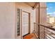 Condo front door with railing and light-filled side panel at 7609 E Indian Bend Rd # 2008, Scottsdale, AZ 85250