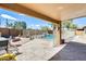 Covered patio area overlooking a fenced pool and landscaped backyard, perfect for outdoor entertaining at 7712 N 54Th Ln, Glendale, AZ 85301