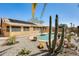 Backyard featuring a pool, desert landscaping, and a fenced perimeter, creating a private outdoor space at 7712 N 54Th Ln, Glendale, AZ 85301