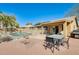 Inviting backyard with a fenced pool, patio furniture, and a built-in grill, ideal for outdoor gatherings at 7712 N 54Th Ln, Glendale, AZ 85301