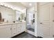 Modern bathroom featuring double sinks, a glass-enclosed shower, and stylish finishes at 7712 N 54Th Ln, Glendale, AZ 85301