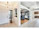 Inviting foyer with arched openings, tiled flooring, and stylish lighting fixtures at 7712 N 54Th Ln, Glendale, AZ 85301