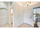 Bright entryway showcasing tile flooring and a view of the laundry room at 7712 N 54Th Ln, Glendale, AZ 85301