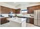 Modern kitchen with stainless steel appliances, a center island, and ample counter space at 7712 N 54Th Ln, Glendale, AZ 85301