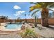 Lush backyard featuring a sparkling pool, palm trees, and desert landscaping, creating a serene oasis at 7712 N 54Th Ln, Glendale, AZ 85301