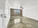 A bedroom offers a ceiling fan and a view of the front yard through the window at 776 S Saguaro Dr, Apache Junction, AZ 85120