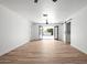 Large living room with wood-look floors, ceiling fan, and glass doors opening up to the backyard at 8525 E Clarendon Ave, Scottsdale, AZ 85251