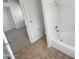 Bathroom featuring tiled flooring, a shower and soaking tub at 8722 W Wilshire Dr, Phoenix, AZ 85037