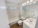 Well-lit bathroom features a vanity, mirror and shower-tub combo at 8722 W Wilshire Dr, Phoenix, AZ 85037