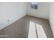 Cozy bedroom featuring carpeted floor and a window offering natural light at 8722 W Wilshire Dr, Phoenix, AZ 85037