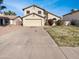 Two-story house with a large driveway, two-car garage, and well-kept yard at 8722 W Wilshire Dr, Phoenix, AZ 85037