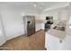 Well-lit kitchen featuring stainless steel appliances, white cabinetry and tile flooring at 8722 W Wilshire Dr, Phoenix, AZ 85037