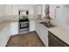 Well-lit kitchen with white cabinets, stainless steel appliances, and tile flooring at 8722 W Wilshire Dr, Phoenix, AZ 85037