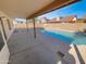 Backyard view of covered patio and refreshing pool at 8722 W Wilshire Dr, Phoenix, AZ 85037