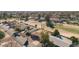 Residential homes nestled in a community with a golf course, enhanced by the surrounding trees and landscape design at 902 S Saranac Ave, Mesa, AZ 85208