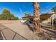 Spacious backyard featuring a covered patio, gravel landscaping, and a fire pit at 902 S Saranac Ave, Mesa, AZ 85208