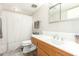 Bathroom featuring a sink with wood finish cabinet, tile countertops, and a shower with curtain at 902 S Saranac Ave, Mesa, AZ 85208