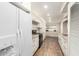 Well-lit kitchen with white cabinets, granite countertops, and a modern refrigerator at 902 S Saranac Ave, Mesa, AZ 85208