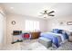 Inviting bedroom with a ceiling fan, window with shutters, and a comfortable bed with blue accents at 10002 W Shasta Dr, Sun City, AZ 85351