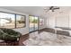 Bright bedroom with natural light, modern ceiling fan, and neutral carpet at 10259 N 102Nd Dr, Sun City, AZ 85351