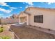 Back of house with covered patio and a rock lined yard at 10814 W Alvarado Rd, Avondale, AZ 85392