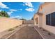 Backyard with a block wall, gravel and small plantings at 10814 W Alvarado Rd, Avondale, AZ 85392