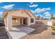 Rear view of a home with a covered patio, a concrete area, and a landscaped backyard at 10814 W Alvarado Rd, Avondale, AZ 85392