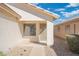 Exterior of the house, showcasing a covered front entrance and a secure metal security door at 10814 W Alvarado Rd, Avondale, AZ 85392