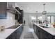 Modern kitchen with dark cabinets, quartz countertops, stainless steel appliances, and a spacious layout at 11242 E Crescent Ave, Mesa, AZ 85208