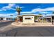 Delightful mobile home with a convenient covered carport, accented by lush desert landscaping for curb appeal at 11411 N 91St Ave # 48, Peoria, AZ 85345