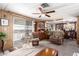 Inviting living room bathed in natural light, featuring comfortable seating and a seamless flow to the dining area at 11411 N 91St Ave # 48, Peoria, AZ 85345