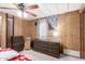 Bedroom with carpet flooring, wood-paneled walls, and a ceiling fan at 11411 N 91St Ave # 48, Peoria, AZ 85345