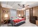 Cozy bedroom featuring wood-paneled walls, carpet flooring, and ample natural light at 11411 N 91St Ave # 48, Peoria, AZ 85345