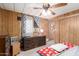 Bedroom with carpet flooring, wood-paneled walls, and a ceiling fan at 11411 N 91St Ave # 48, Peoria, AZ 85345