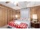 Comfortable bedroom featuring wood-paneled walls, carpet flooring, and a ceiling fan at 11411 N 91St Ave # 48, Peoria, AZ 85345