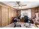 Office with carpet flooring, wood-paneled walls, and a ceiling fan at 11411 N 91St Ave # 48, Peoria, AZ 85345