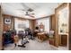 Office space with a ceiling fan, carpet flooring, and wood-paneled walls at 11411 N 91St Ave # 48, Peoria, AZ 85345