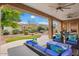 Relax on this covered back patio, perfect for gatherings, with stylish outdoor seating with tropical-themed cushions at 12663 W Pinnacle Vista Dr, Peoria, AZ 85383