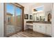 Bright bathroom with double sinks, granite countertops, and a view of a private courtyard at 12663 W Pinnacle Vista Dr, Peoria, AZ 85383