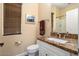 Well-lit bathroom featuring granite countertops, a vanity with sink, and a shower with white tile at 12663 W Pinnacle Vista Dr, Peoria, AZ 85383