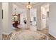 Open-concept foyer that flows into the dining area and kitchen with eye-catching, decorative rug at 12663 W Pinnacle Vista Dr, Peoria, AZ 85383