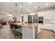 Modern kitchen features granite countertops, stainless steel appliances, island with seating, and an open floor plan at 12663 W Pinnacle Vista Dr, Peoria, AZ 85383