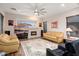 Cozy living room featuring a stone fireplace, large windows, and comfortable seating at 12663 W Pinnacle Vista Dr, Peoria, AZ 85383