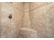 Tiled shower showcasing neutral-colored tiles with decorative border and corner seat at 12663 W Pinnacle Vista Dr, Peoria, AZ 85383