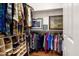 Organized walk-in closet with shelving, hanging racks, and a variety of clothing and shoes at 12663 W Pinnacle Vista Dr, Peoria, AZ 85383