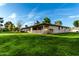 Wonderful backyard showcasing a lush lawn, covered patio, and well-maintained landscaping at 12703 W Shadow Hills Dr, Sun City West, AZ 85375