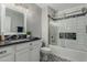 The remodeled bathroom features decorative tile, vanity, mirror, and tiled shower and tub combo at 12703 W Shadow Hills Dr, Sun City West, AZ 85375